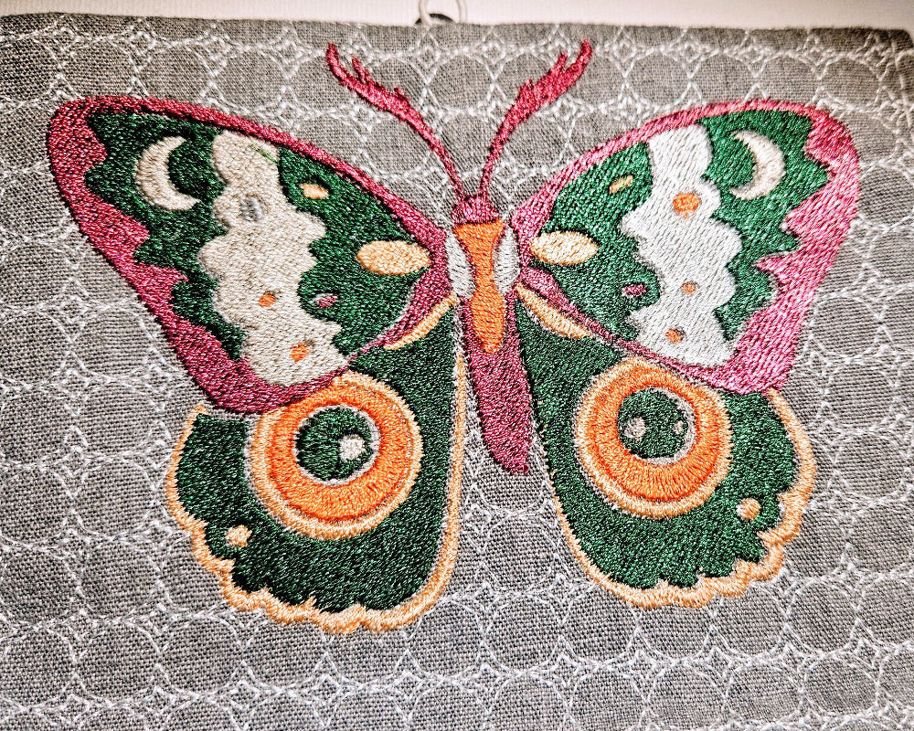 butterfly embroidered on the grey notebook