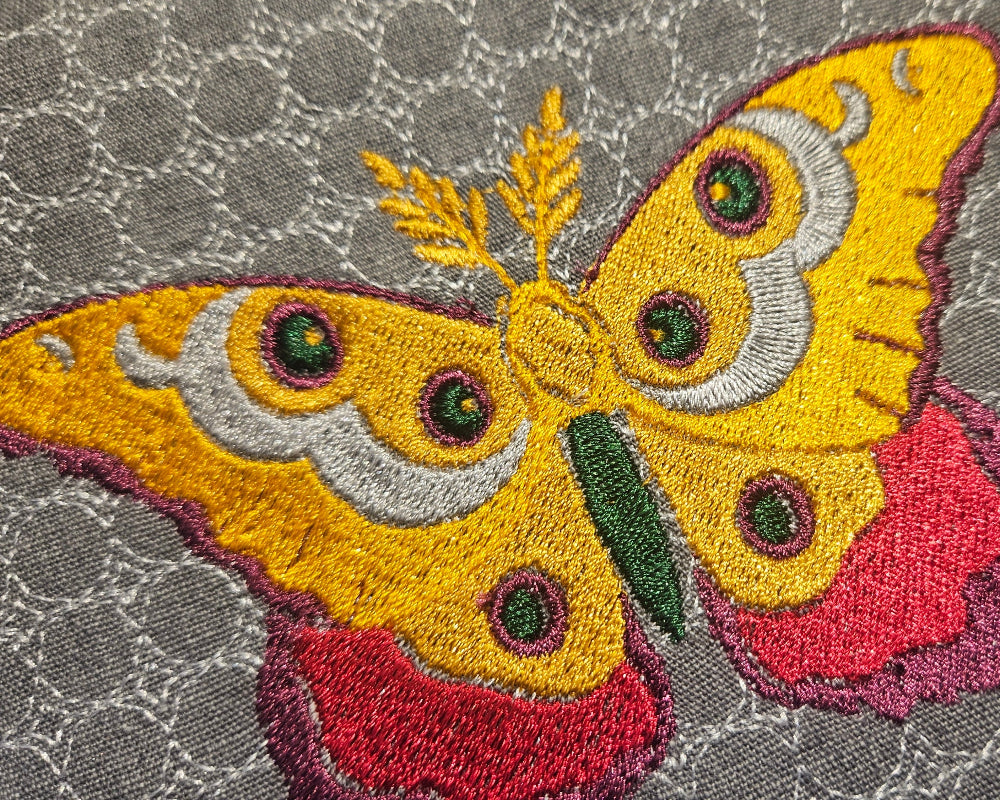 butterfly yellow embroidered on a grey notebook